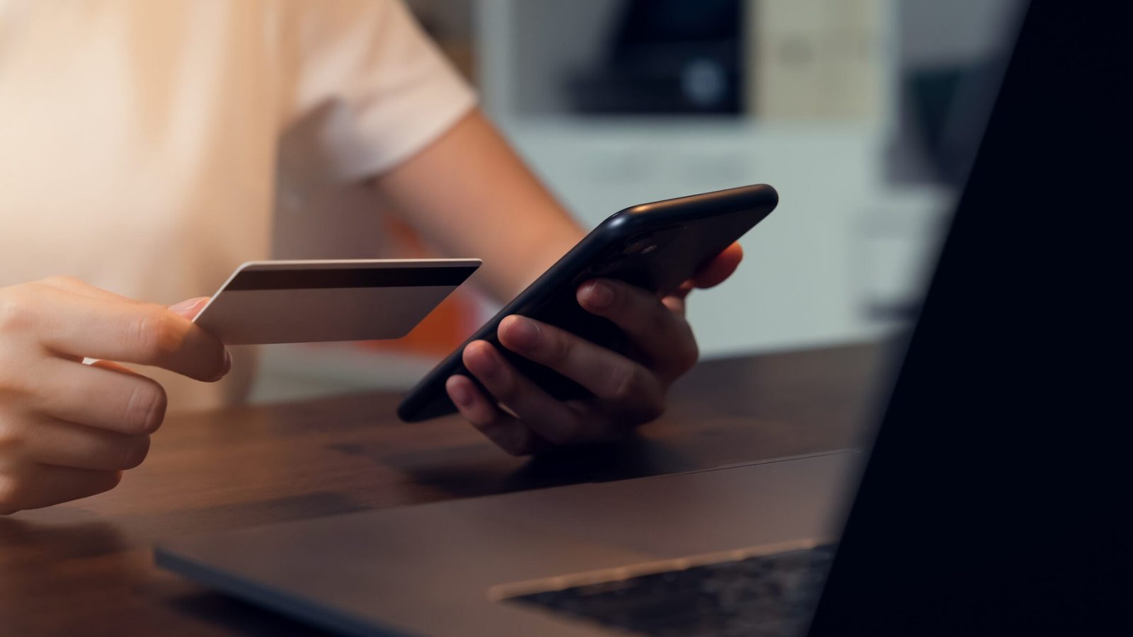 Woman hand using smartphone and holding credit card with payment online on mobile.